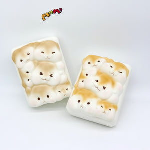 Two cute hamster toast slow rise squishy toys side by side, white foam with golden brown markings