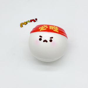 Single white ping pong ball squishy wearing red Must Win headband, frowning face, white background
