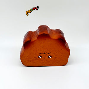 Milk Haas Bread Squishy - Chocolate Brown & Original Bread Yellow - slow rising squeeze toy side angle view