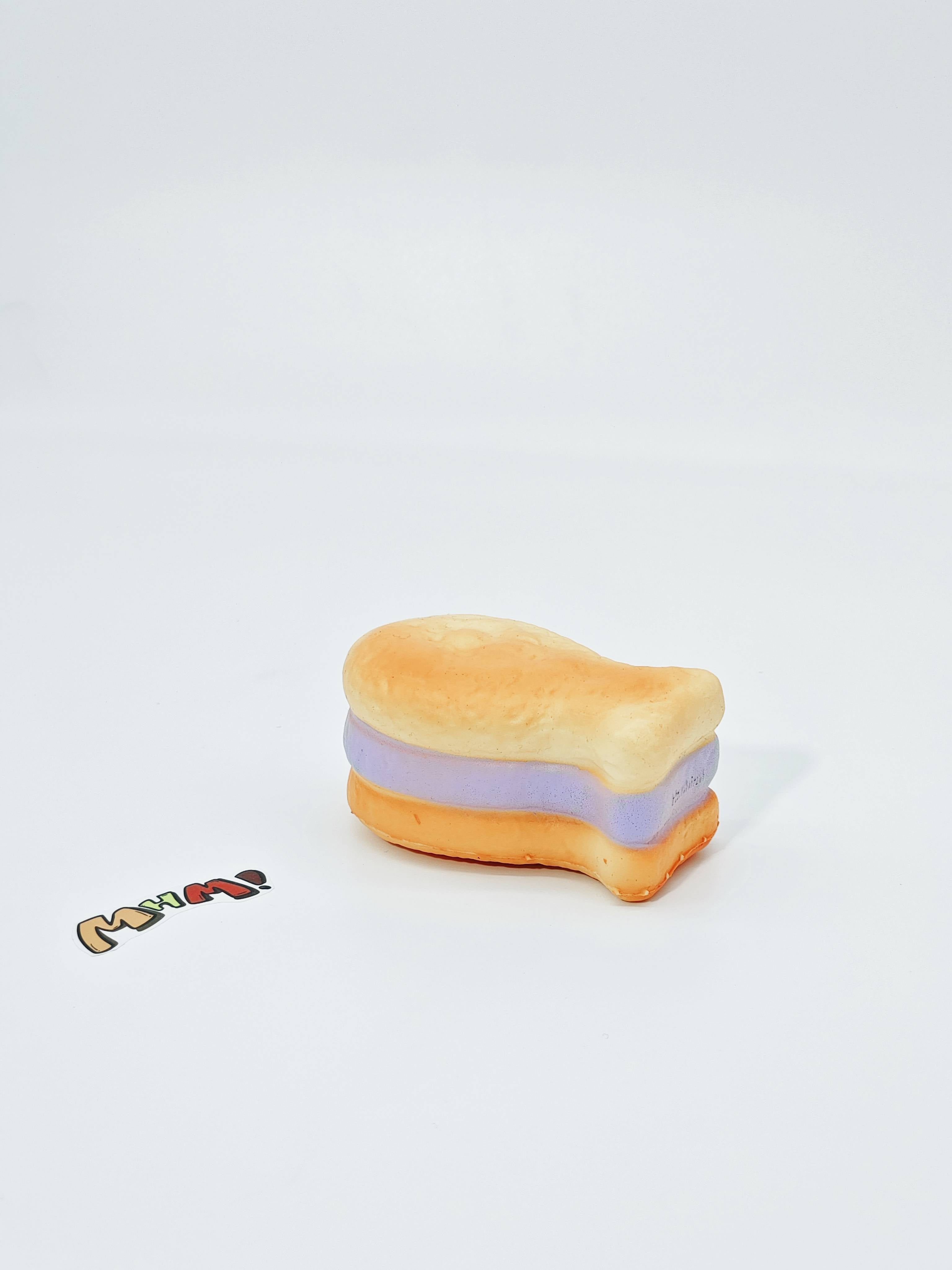Purple Filling Fish Cake Squishy | Snack Themed Slow Rising Stres - soft slow rise fidget toy front view
