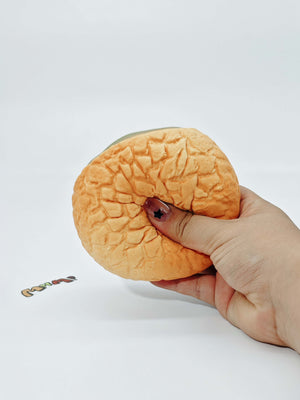 Hand squeezing soft green tea foam stress toy showing slow rising texture for anxiety