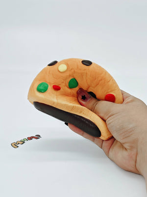 Hand squeezing sticky marshmallow cookie stress toy showing slow rising foam texture
