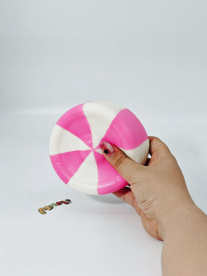 Hand squeezing sticky taffy candy stress toy showing slow rising foam for anxiety relief