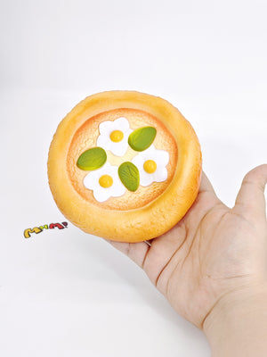 Close up of white cream topping and sticky surface on soft pizza squishy slow rising toy