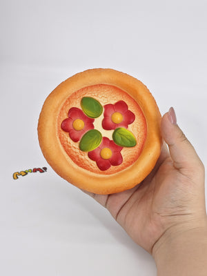 Close up of red topping and sticky surface on soft pizza squishy slow rising toy