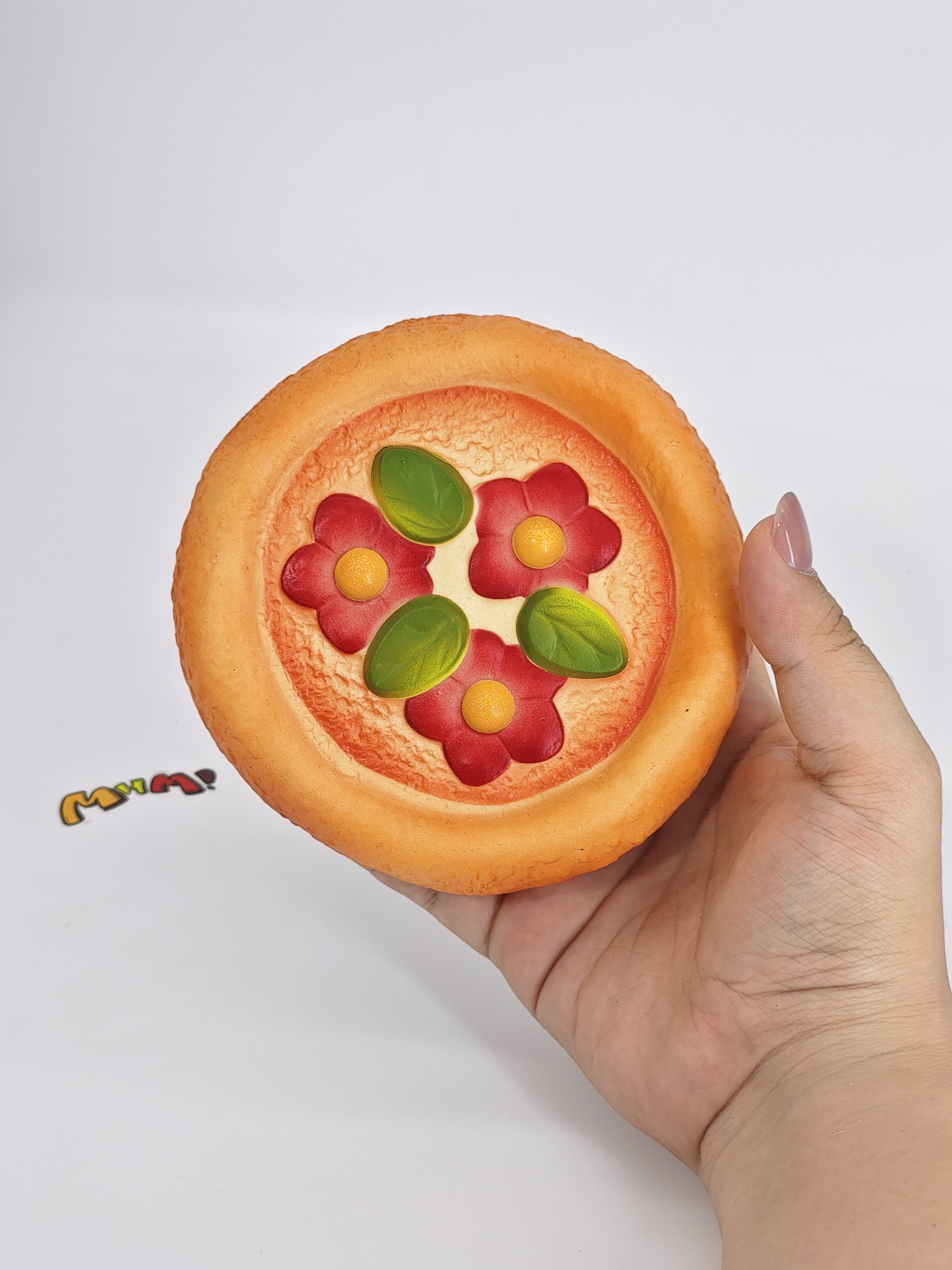 Close up of red topping and sticky surface on soft pizza squishy slow rising toy