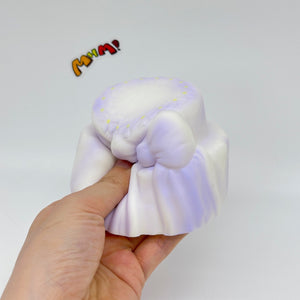 Cute Two-Tier Cake Stress Relief Squishy with Bow - squishy toy size reference with hand