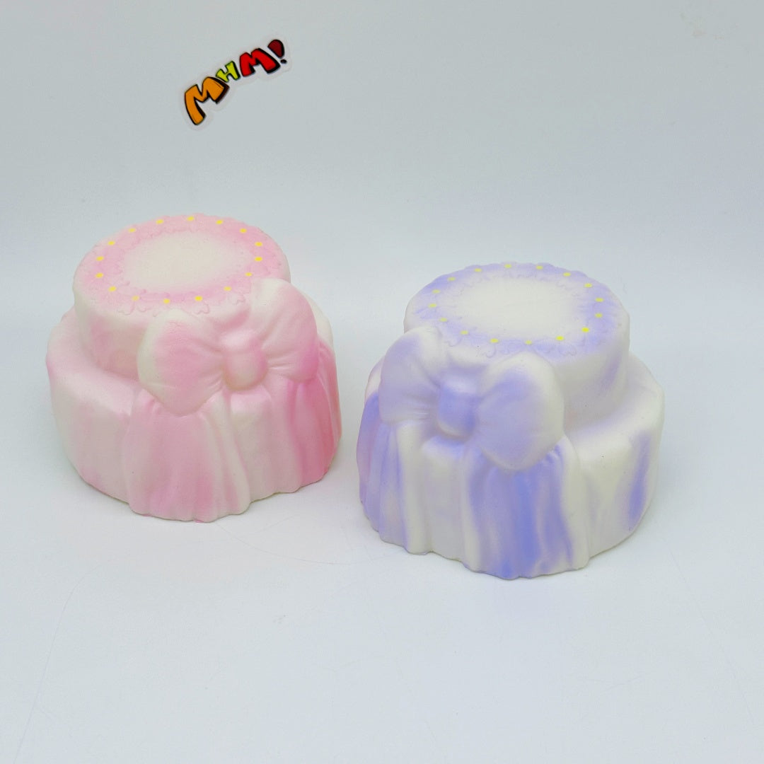 Cute Two-Tier Cake Stress Relief Squishy with Bow - slow rising squeeze toy side angle view