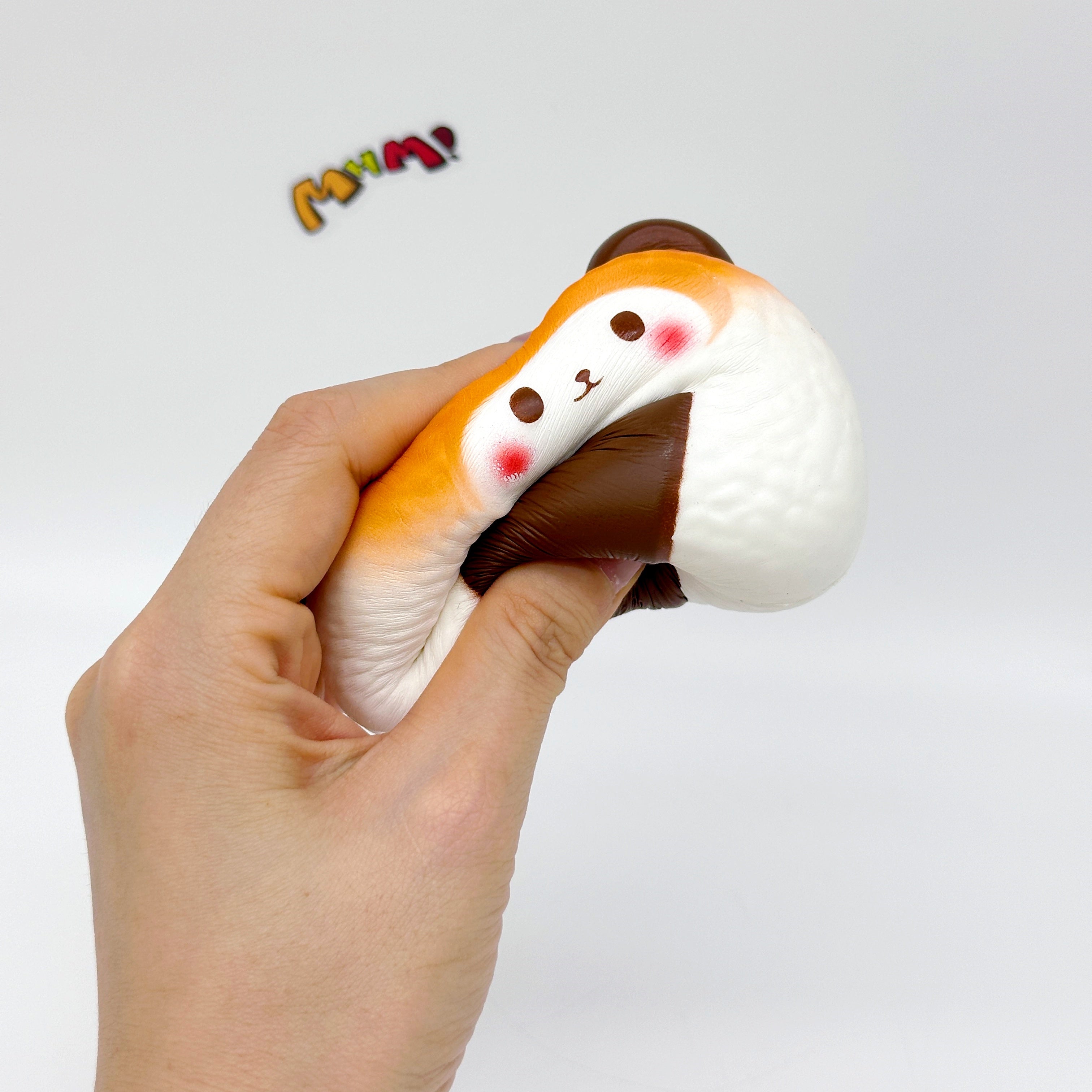 Handheld Bear Onigiri Squishy with Cute Face & Flavor Details - slow rise fidget toy texture close up