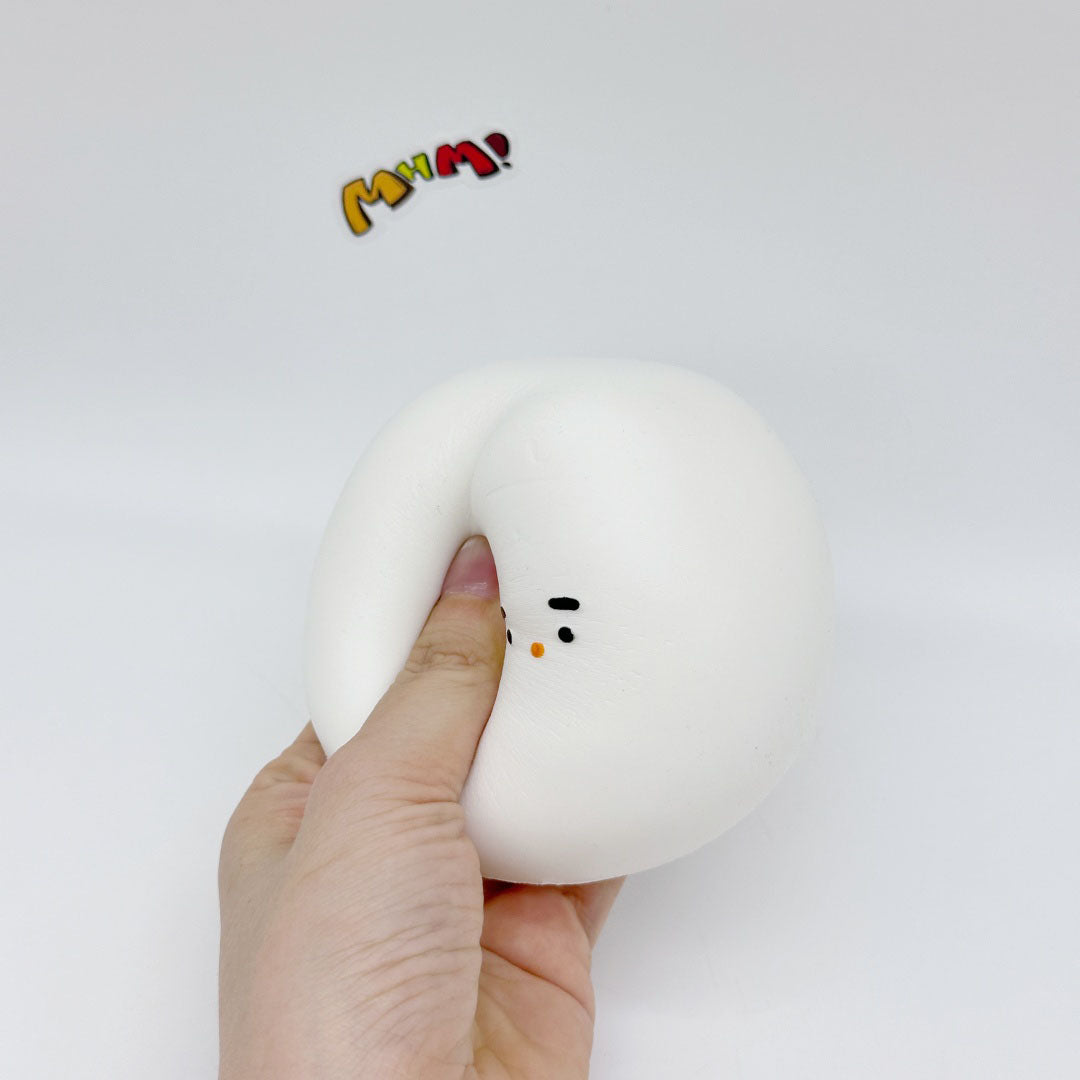Hand squeezing white chonky bird squishy toy, slow-rise foam deforming under finger pressure