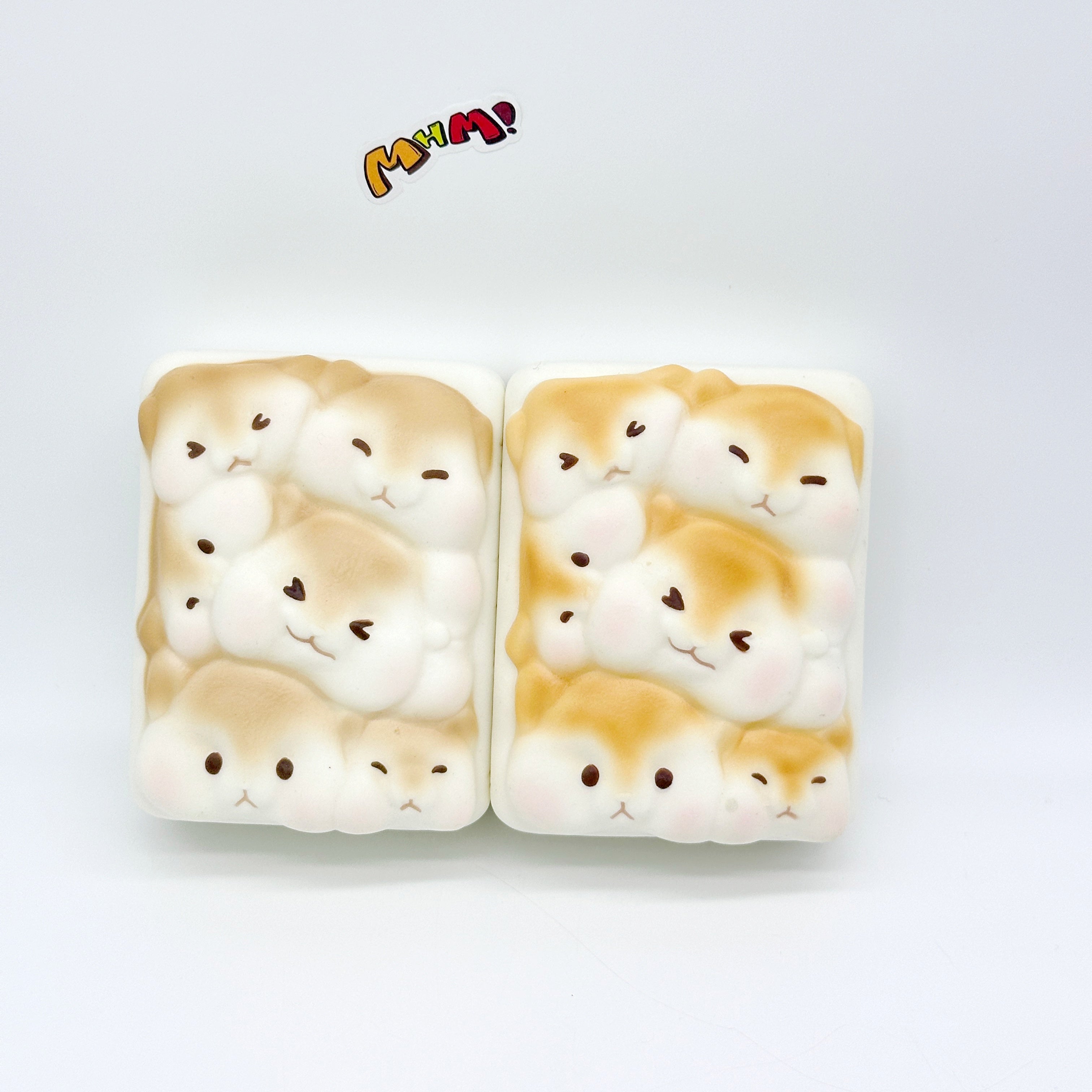 Pair of hamster toast squishies displayed front view showing soft slow-rise foam texture