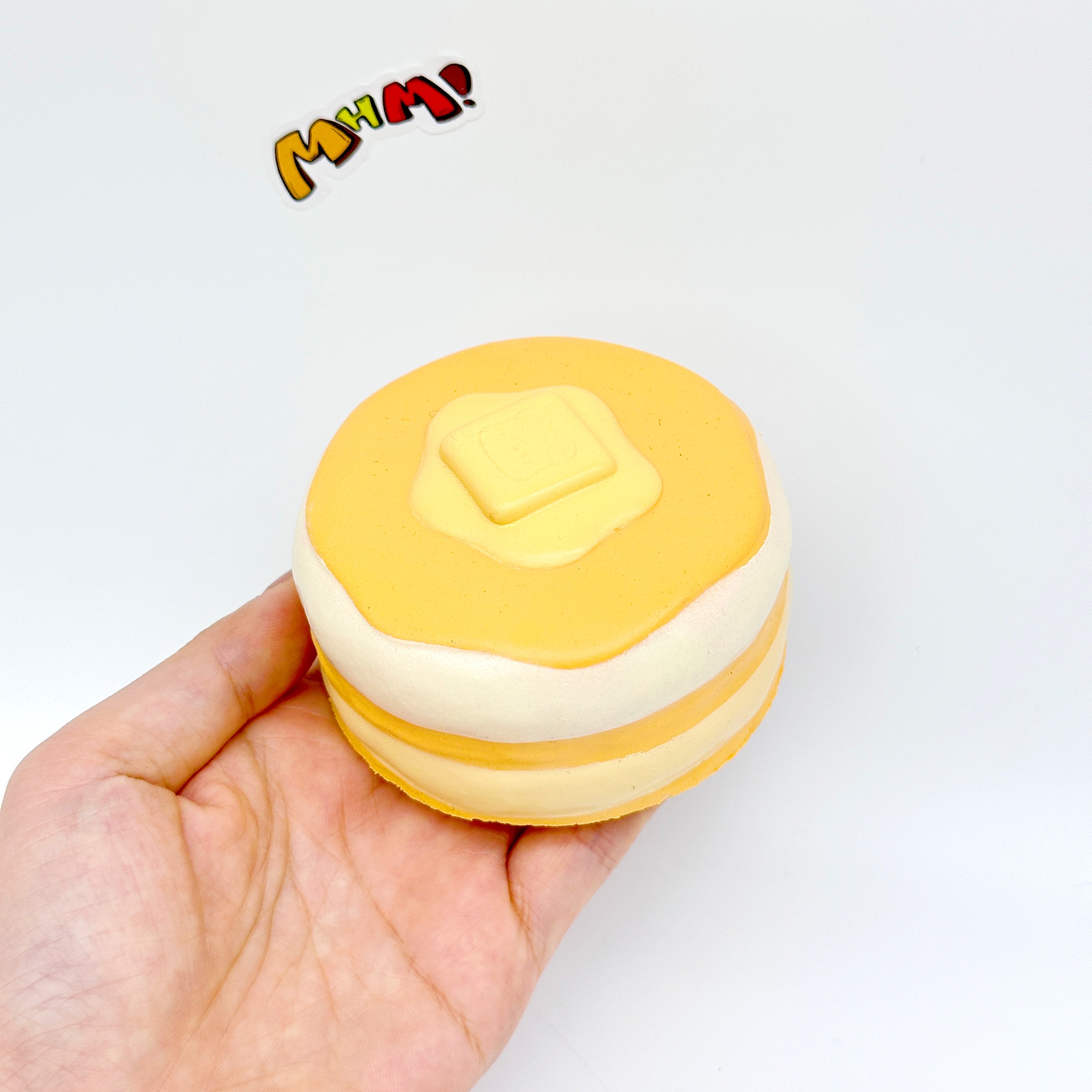 Honey bread pancake squeeze toy with butter topping held in hand