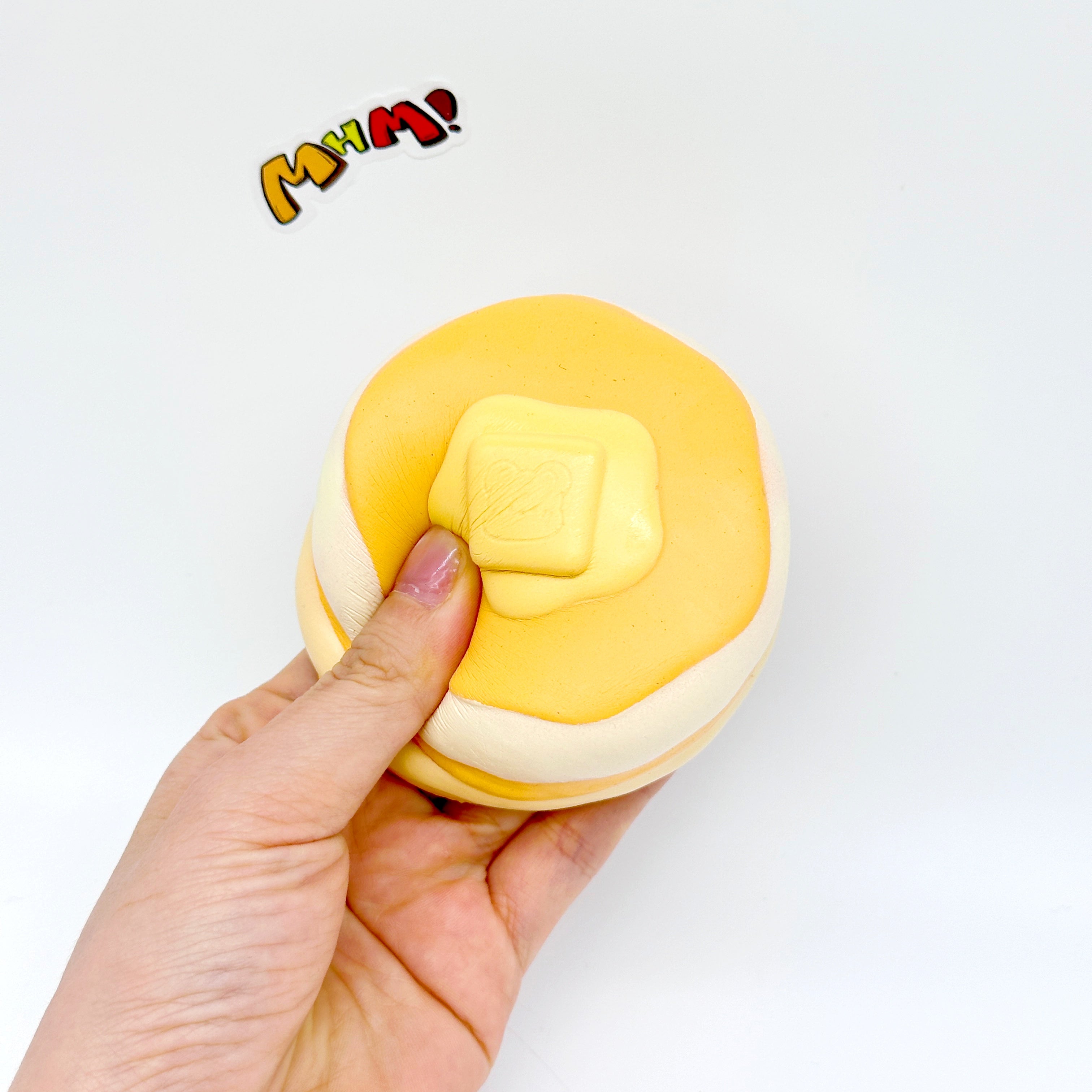 Slow rising pancake squishy stress toy being squeezed showing soft texture