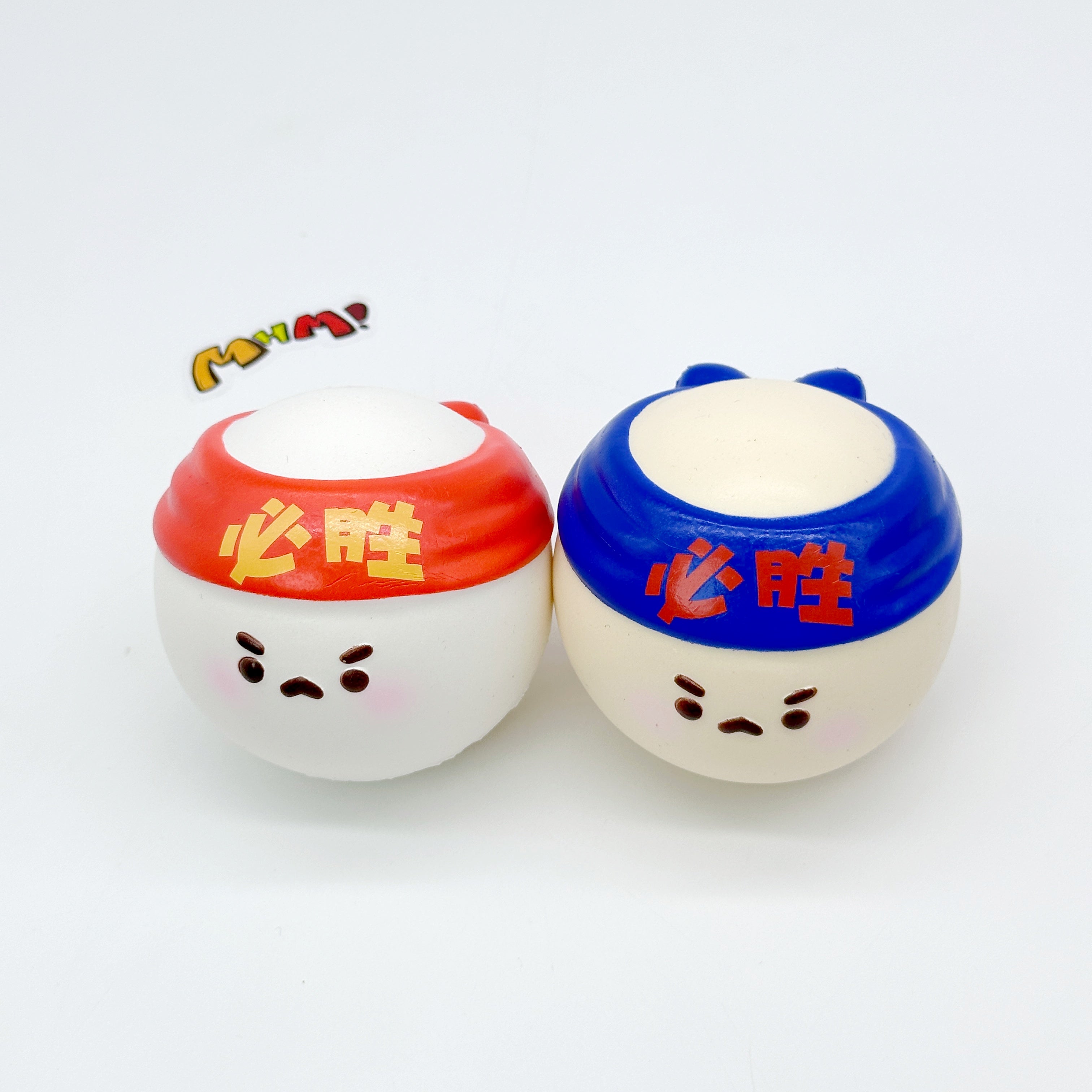 Two Must Win squishy ping pong balls side by side, red and blue headbands, showing squeezed flat top shape