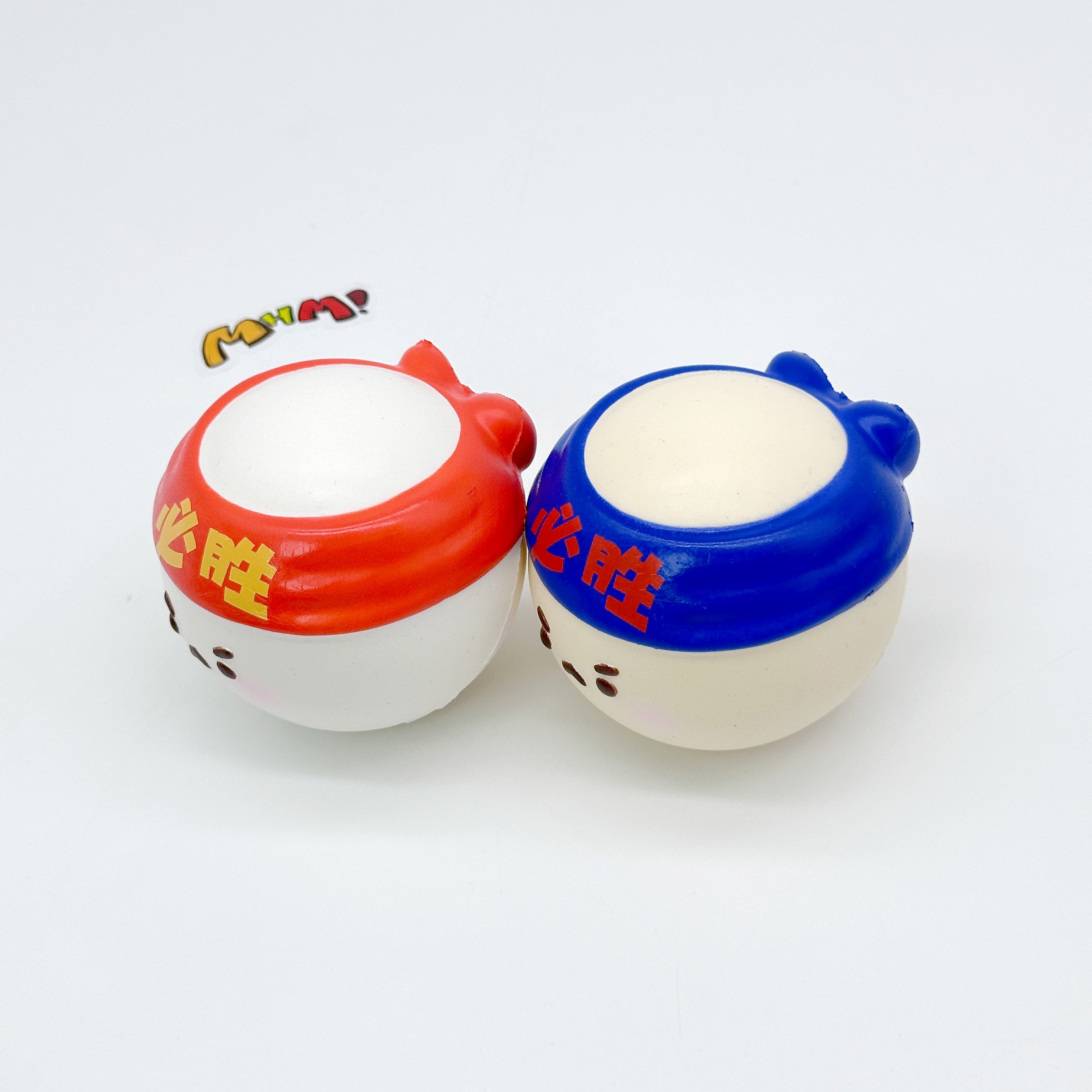 Two table tennis ball squishies with red and blue headbands printed with Chinese characters, back view