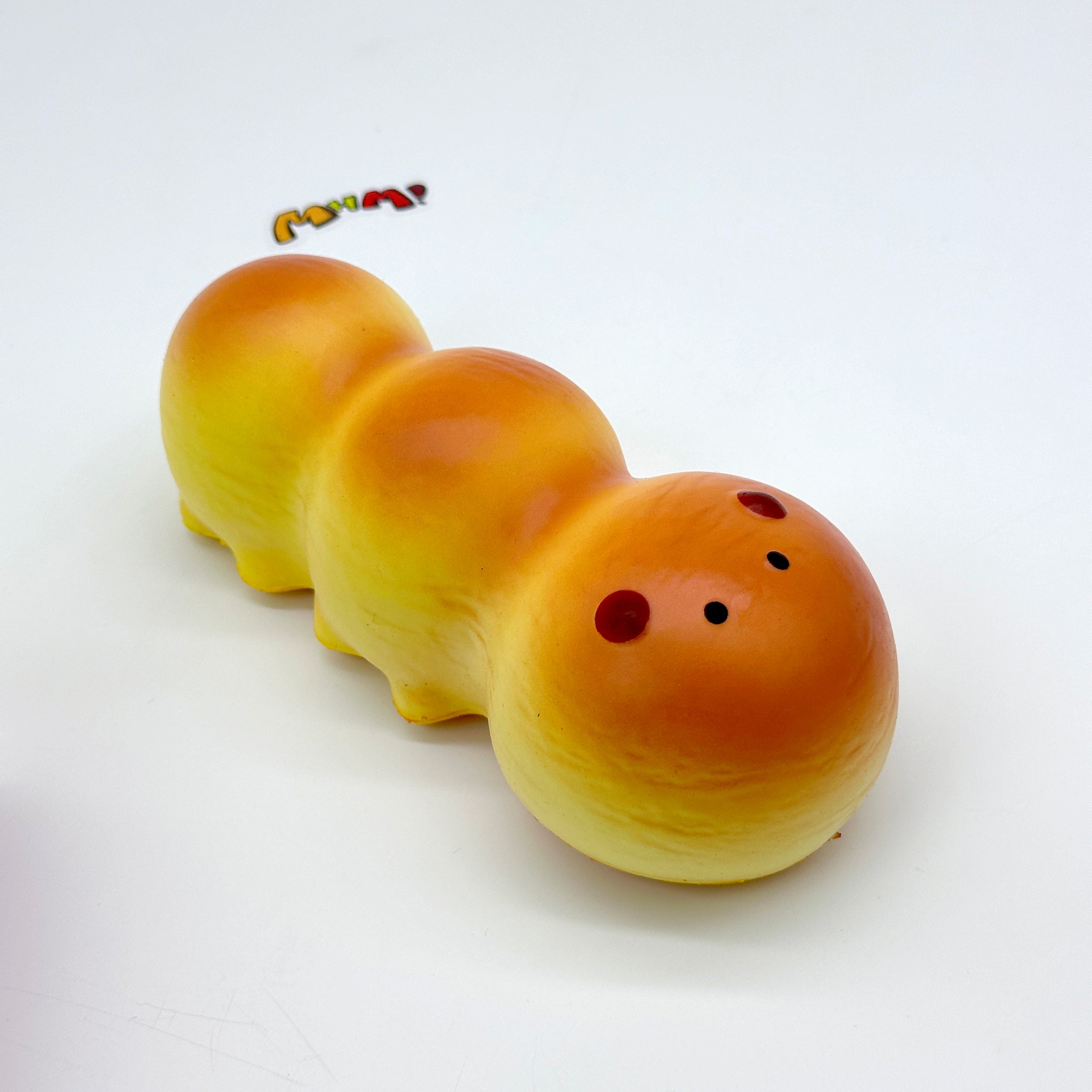 Fluffy Caterpillar Bread Squishy - slow rising squeeze toy side angle view