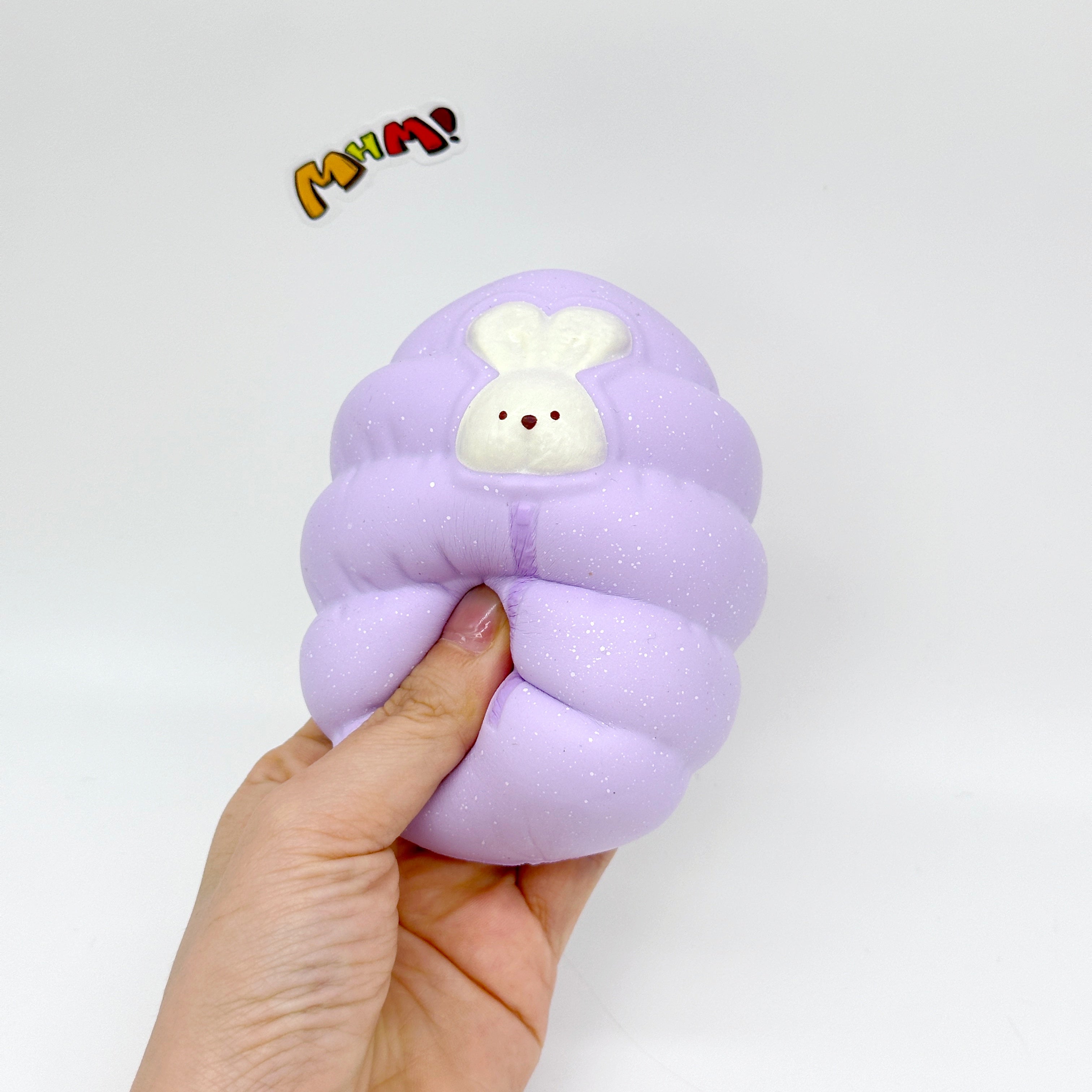 Sleepy Bunny in Sleeping Bag Squishy - squishy toy size reference with hand