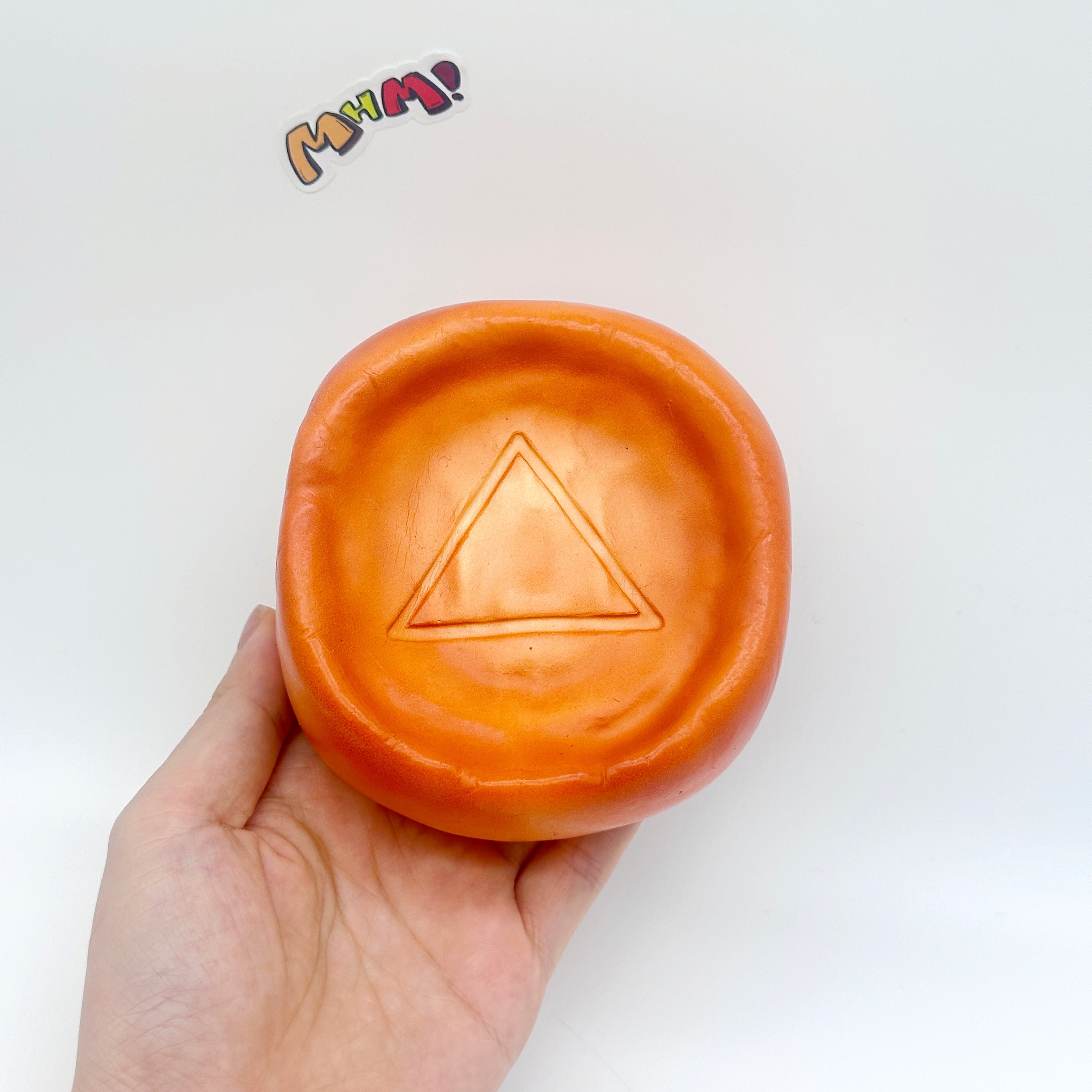 Caramel Dalgona Candy Squishy | Triangle Pattern Sugar Honeycomb  - slow rising squeeze toy side angle view