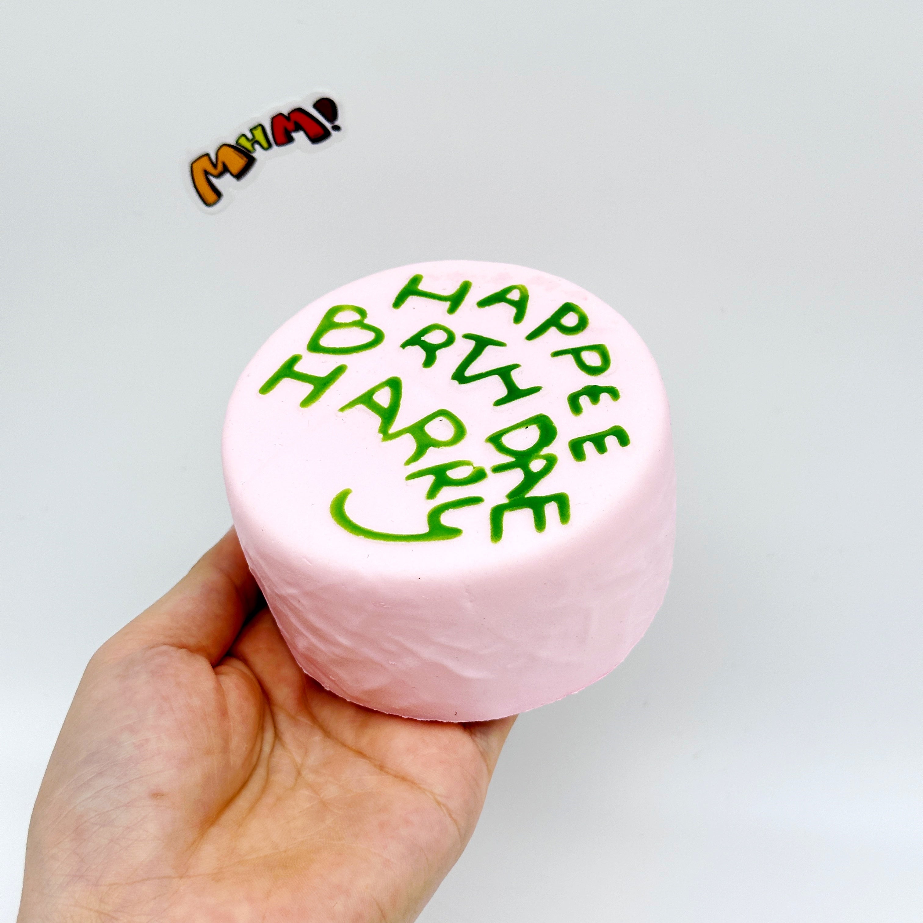 Happee Birthdae Harry Pink Cake Squishy | Birthday Themed Slow Ri - slow rising squeeze toy side angle view