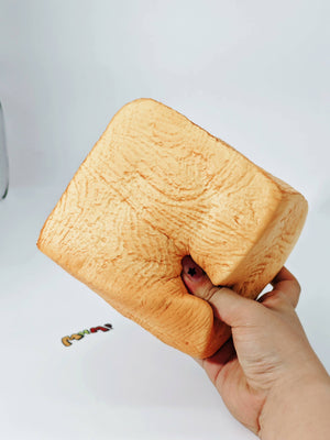 Hand squeezing sticky taba bread stress toy showing slow rebound dough feel for anxiety