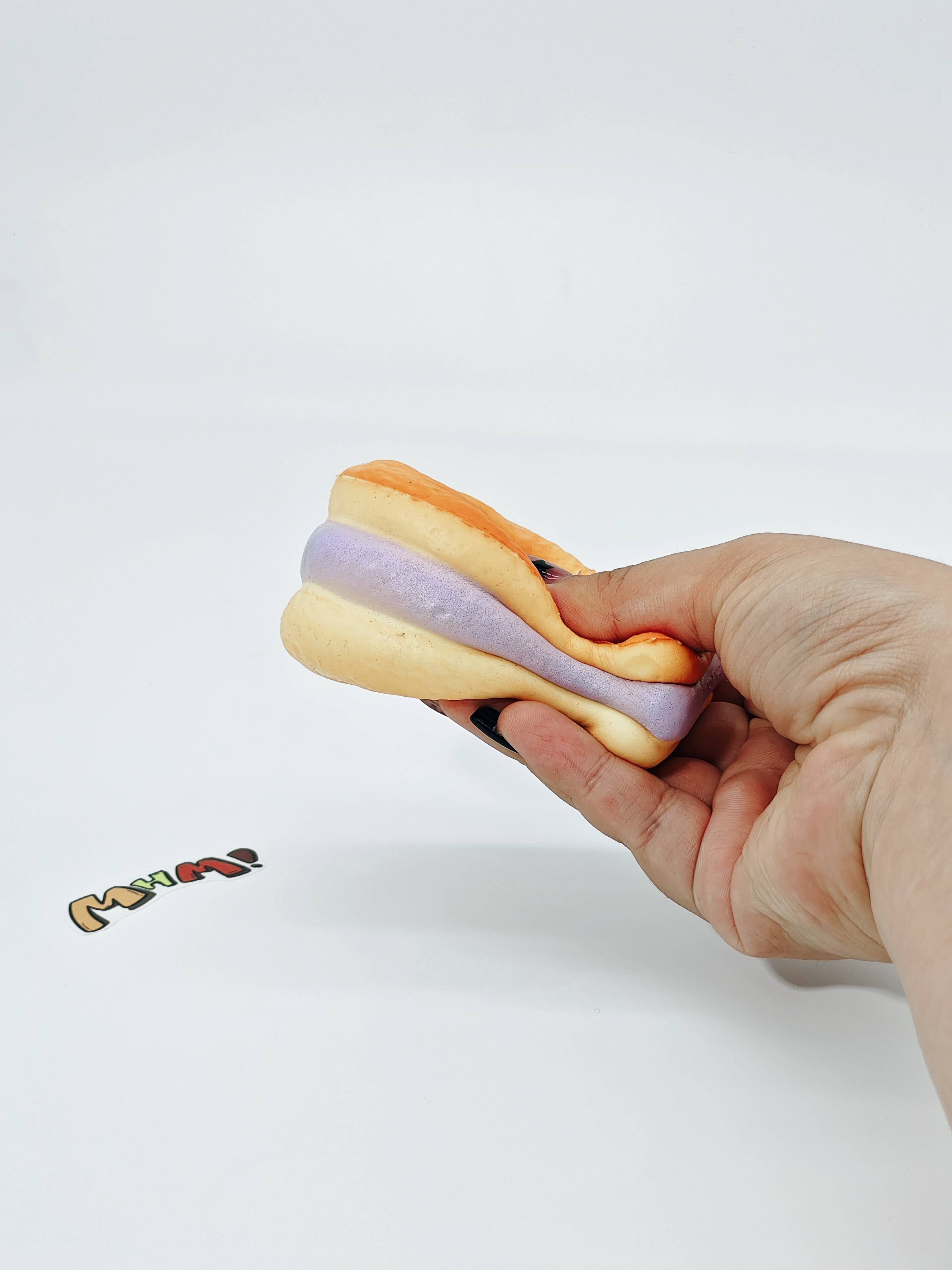 Purple Filling Fish Cake Squishy | Snack Themed Slow Rising Stres - slow rising squeeze toy side angle view