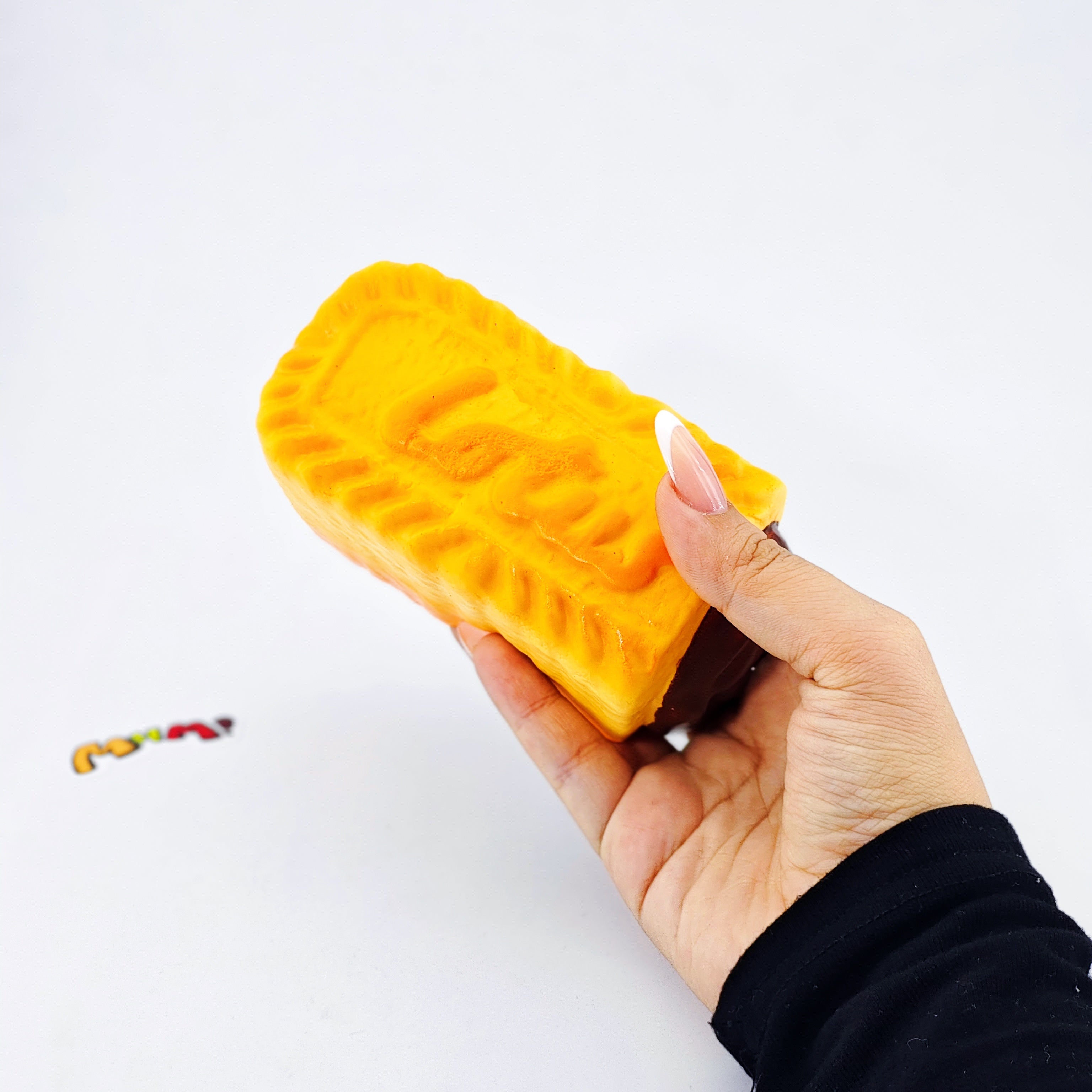 Dark Thick Filled Milk Biscuit Squishy | Snack Themed Slow Rising - slow rising squeeze toy side angle view